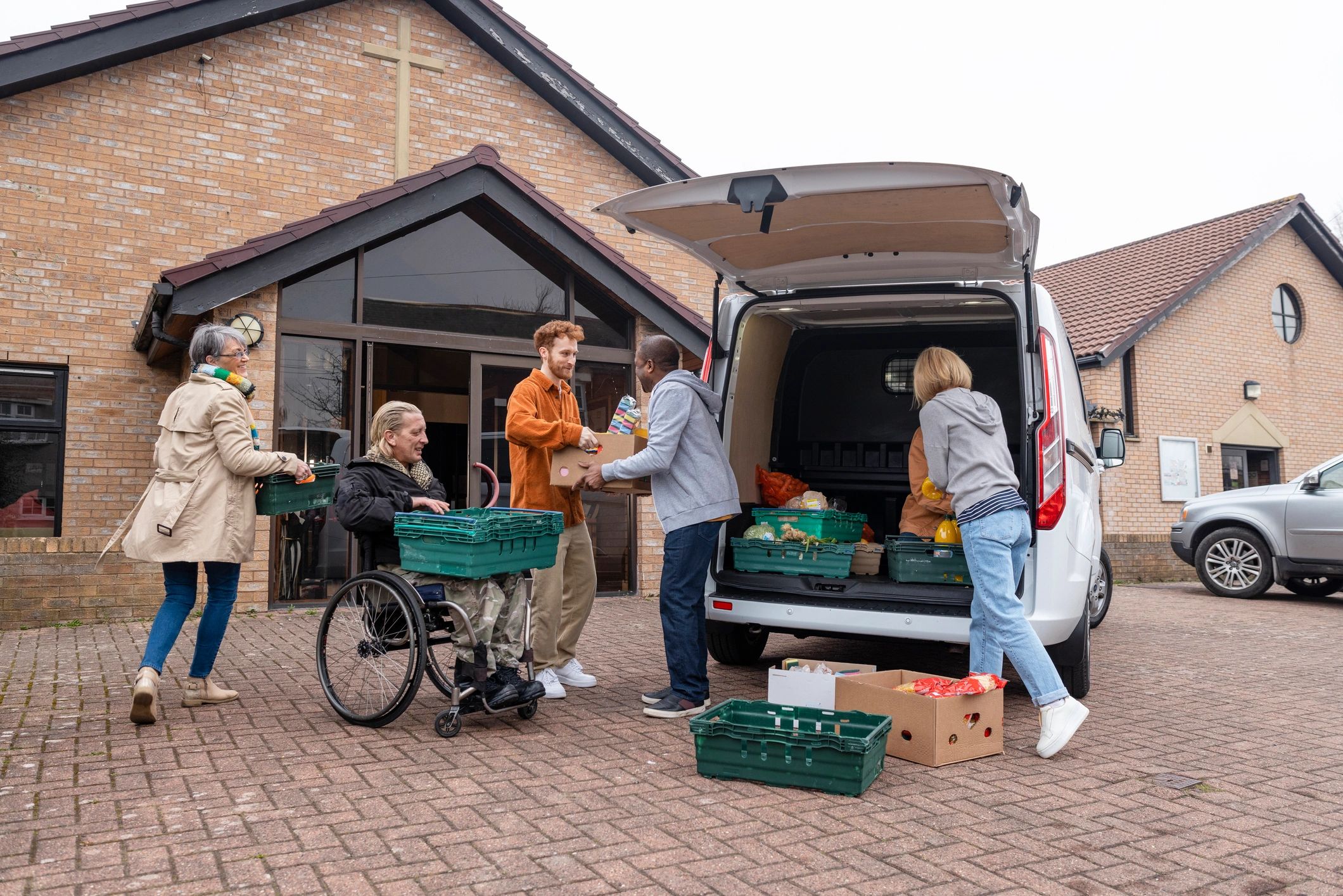 Volunteers working together to distribute food support